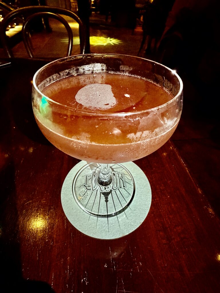 Hallowed By Thy Grove Halloween cocktail in a coupe glass at The Edison, Disney Springs