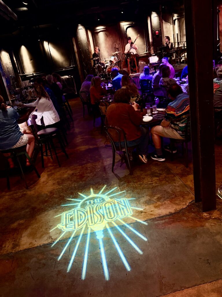 The Edison logo projected on the floor of the dining room at Disney Springs