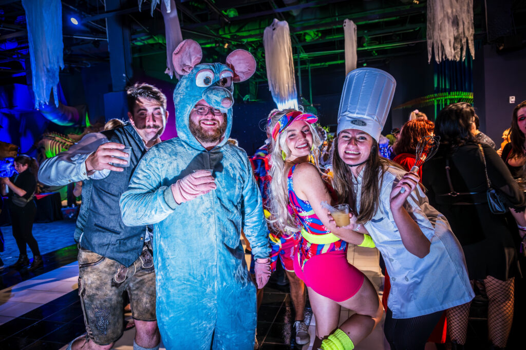 Friends in rat and chef costumes posing together at OSC After Dark, Orlando Science Center
