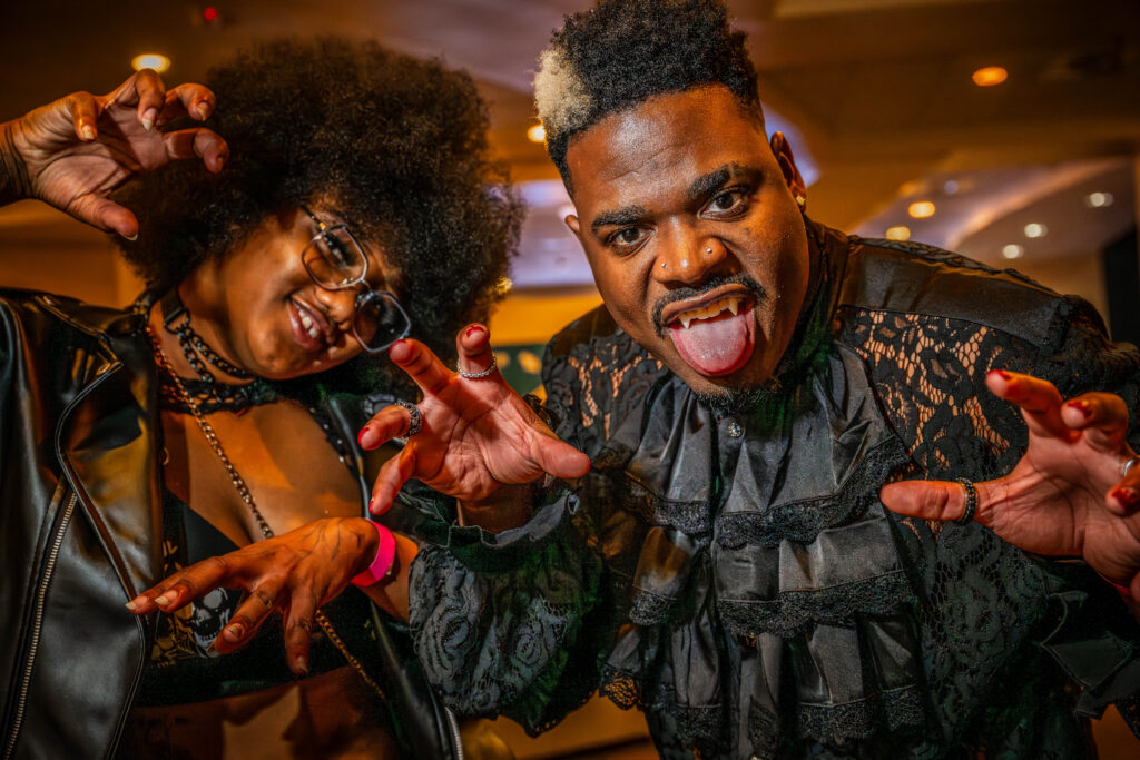 Two guests in Halloween costumes making spooky faces at OSC After Dark, Orlando Science Center